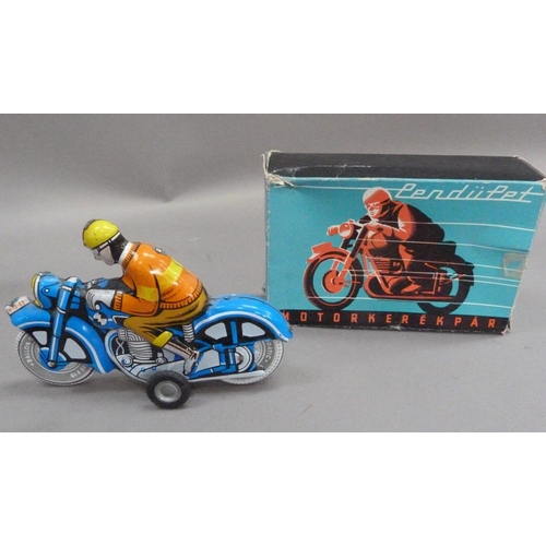 203 - A Zetor tinplate tractor and trailer, a PenduPet tinplate motorcyclist in original box, a Chad Valle... 