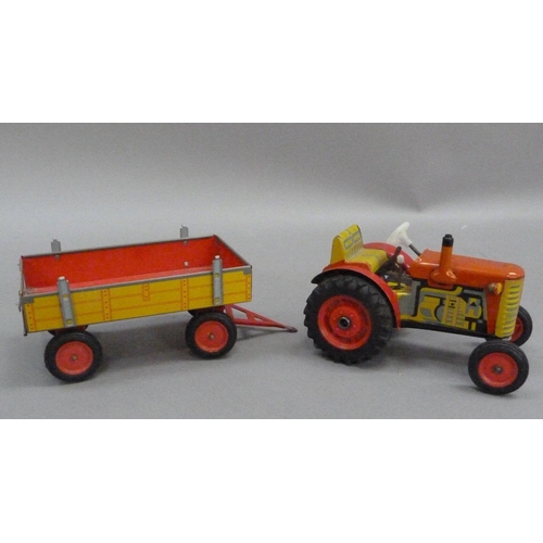 203 - A Zetor tinplate tractor and trailer, a PenduPet tinplate motorcyclist in original box, a Chad Valle... 