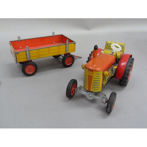 203 - A Zetor tinplate tractor and trailer, a PenduPet tinplate motorcyclist in original box, a Chad Valle... 