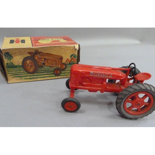 224 - An International Harvester Farmall M Tractor, plastic model, in original box, together with a Britai... 