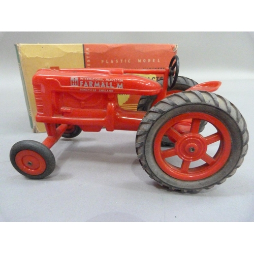 224 - An International Harvester Farmall M Tractor, plastic model, in original box, together with a Britai... 