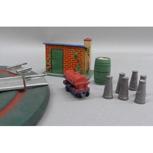 232 - A Hornby O gauge turntable, a plate layer's hut, six milk churns and a Hornby shell tanker