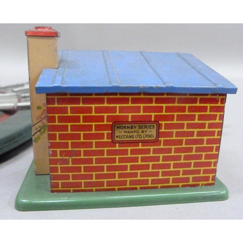 232 - A Hornby O gauge turntable, a plate layer's hut, six milk churns and a Hornby shell tanker