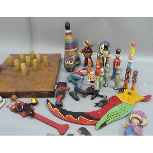 235 - A bar skittles game together with a collection of painted wooden toys including a balancing parrot, ... 