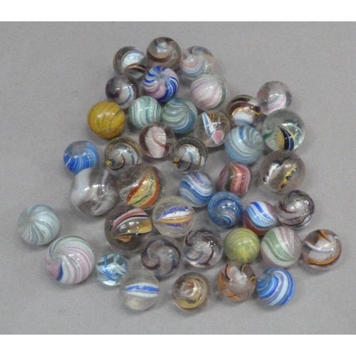 243 - A collection of vintage marbles to include multi-coloured swirls with white and coloured latticino a... 