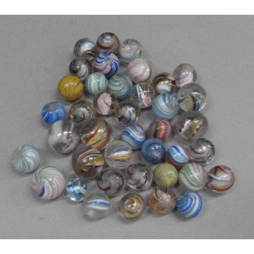 243 - A collection of vintage marbles to include multi-coloured swirls with white and coloured latticino a... 