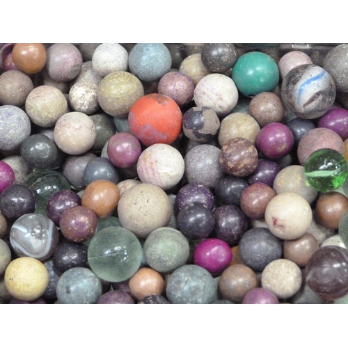 244 - A collection of vintage marbles to include shades of green to blue with a white swirl (approximately... 