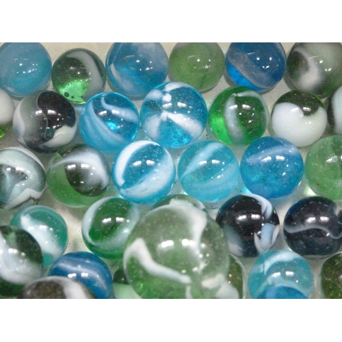 244 - A collection of vintage marbles to include shades of green to blue with a white swirl (approximately... 