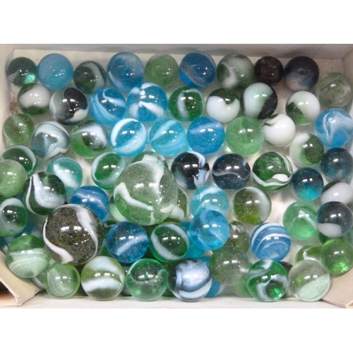 244 - A collection of vintage marbles to include shades of green to blue with a white swirl (approximately... 