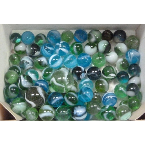 244 - A collection of vintage marbles to include shades of green to blue with a white swirl (approximately... 