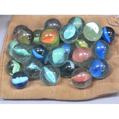 244 - A collection of vintage marbles to include shades of green to blue with a white swirl (approximately... 