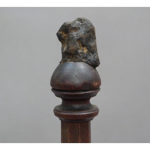 292 - A piece of shrapnel mounted on an oak column with stepped base, labels posted to underside read 'Dis... 