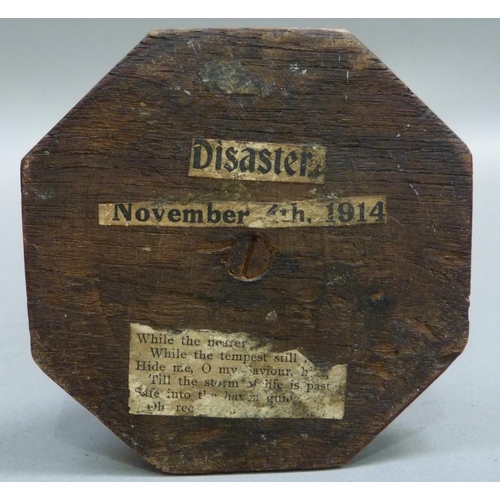 292 - A piece of shrapnel mounted on an oak column with stepped base, labels posted to underside read 'Dis... 