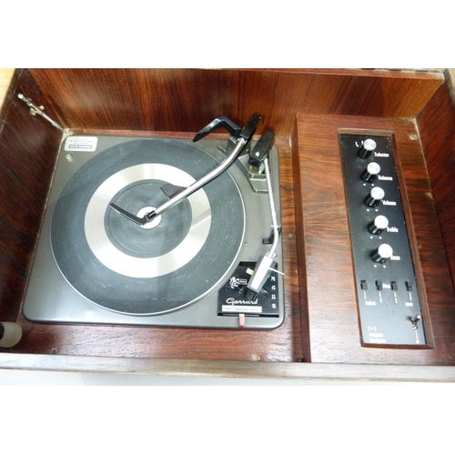 313 - A Dynatron model GR13 record player fitted with a Garrard 3000 turntable, with lift up top, together... 