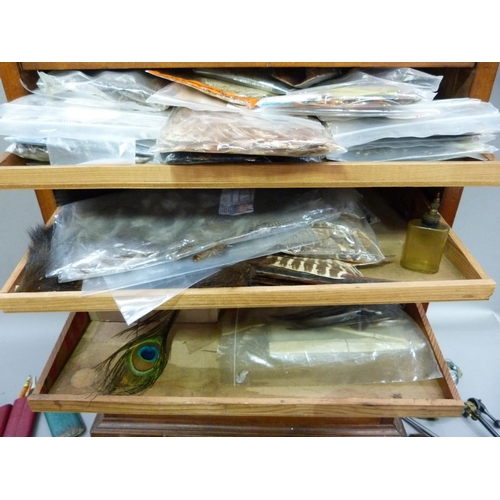 317 - A cabinet of fly tying materials 1950s and later including, tools, colour threads, large selection o... 