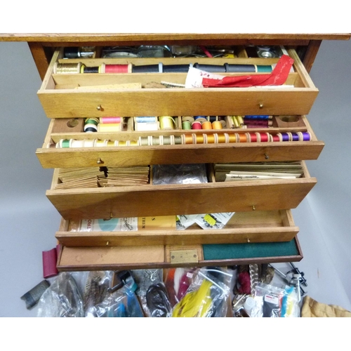 317 - A cabinet of fly tying materials 1950s and later including, tools, colour threads, large selection o... 