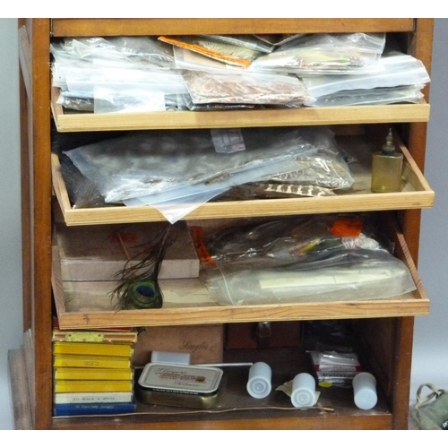 317 - A cabinet of fly tying materials 1950s and later including, tools, colour threads, large selection o... 