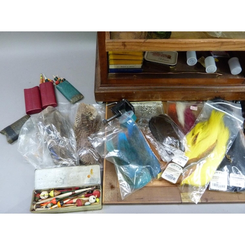 317 - A cabinet of fly tying materials 1950s and later including, tools, colour threads, large selection o... 