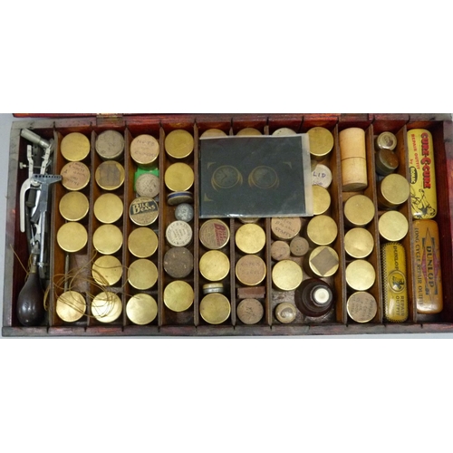 325 - A watchmaker's repair box containing tools and numerous gilt metal tins of watch parts