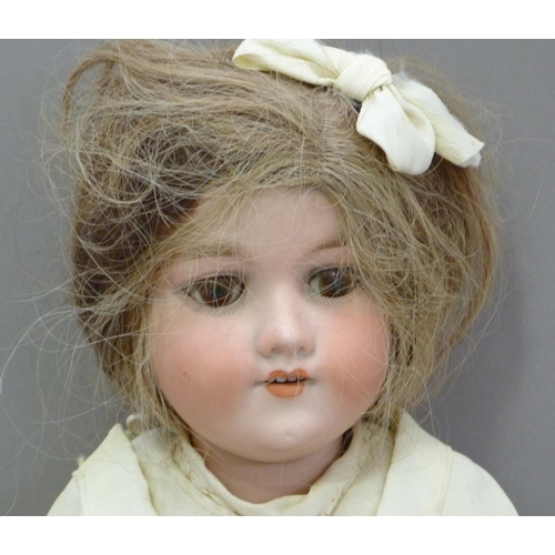 329 - An Armand Marseille bisque headed doll having brown sleeping eyes; open mouth with four teeth, paint... 