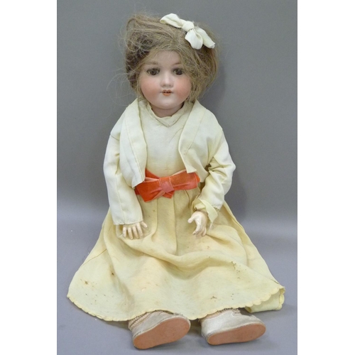 329 - An Armand Marseille bisque headed doll having brown sleeping eyes; open mouth with four teeth, paint... 