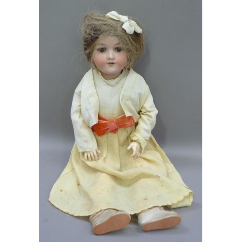 329 - An Armand Marseille bisque headed doll having brown sleeping eyes; open mouth with four teeth, paint... 