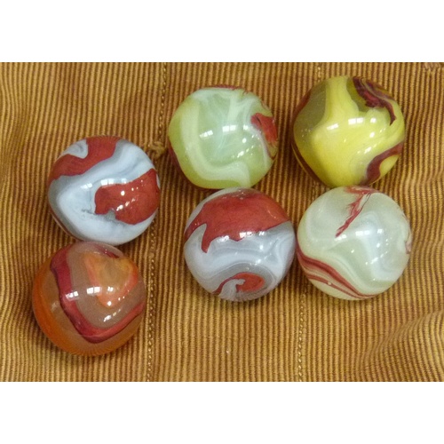 245 - A quantity of vintage marbles to include, red and white opaque, tri-colour swirls, blue with white s... 