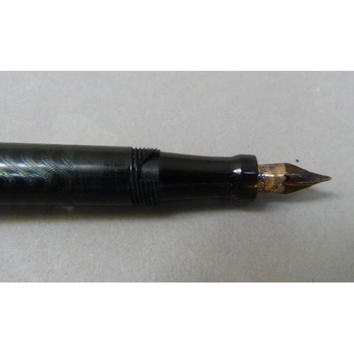 36 - A vintage Conklin crescent filler fountain pen in a black case with wavy decoration 14k nib the yell... 