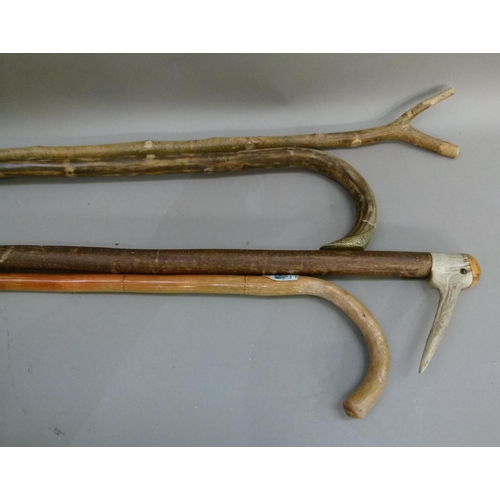 125 - A walking stick with antler handle; together with three other walking sticks (4)