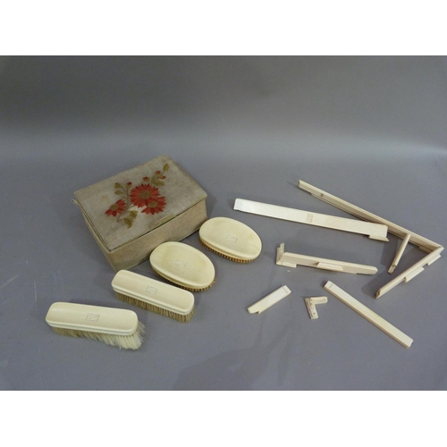 164 - An ivory tray frame; together with four ivory backed brushes, each initialled JK