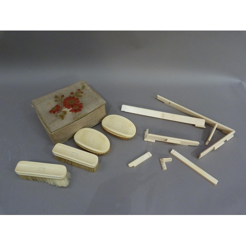 164 - An ivory tray frame; together with four ivory backed brushes, each initialled JK