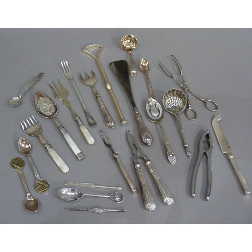 166 - A quantity of silver plated decorative cutlery including asparagus servers, nutcrackers, sifter spoo... 