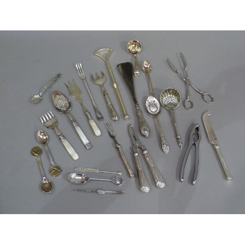 166 - A quantity of silver plated decorative cutlery including asparagus servers, nutcrackers, sifter spoo... 