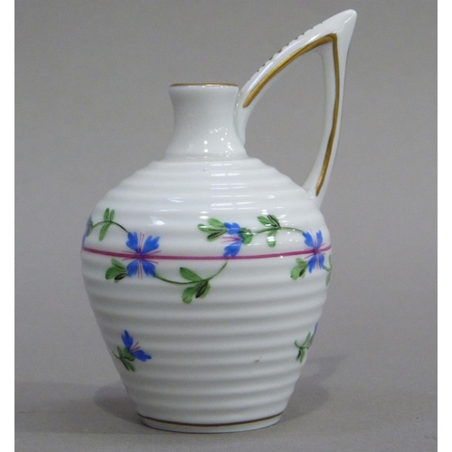 4 - A Herend miniature jug of ribbed form with high angular handle, painted with trailing blue flowers, ... 