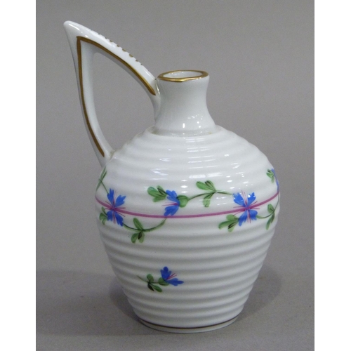 4 - A Herend miniature jug of ribbed form with high angular handle, painted with trailing blue flowers, ... 