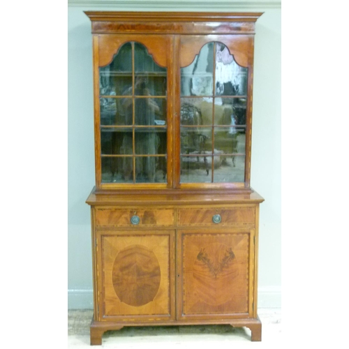 387 - A George III style mahogany bookcase cabinet the flared cornice above a figured frieze and pair of a... 