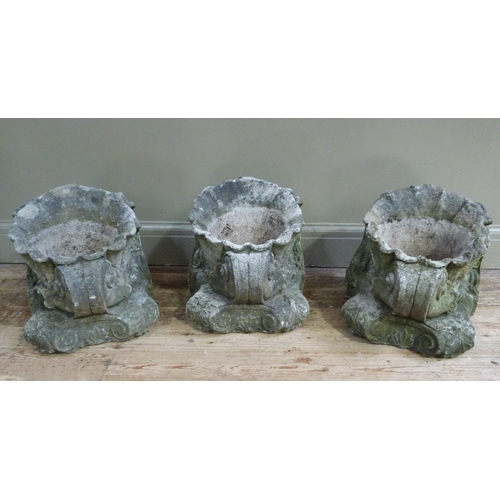 395 - A set of three reconstituted concrete shell planters, each supported on a scrolling corbel, 35cm x 3... 