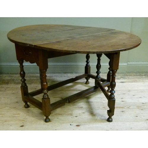 401 - A late 17th century oak gate leg dining table the oval top above pair of drawers, turned baluster le... 