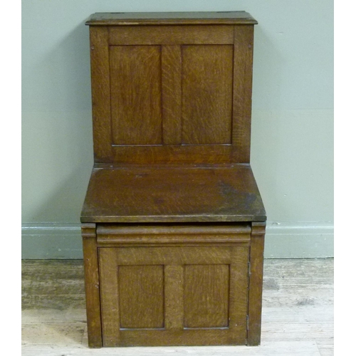 402 - British Sanitary Company, Glasgow - an oak commode the hinged seat revealing enamelled liner above d... 