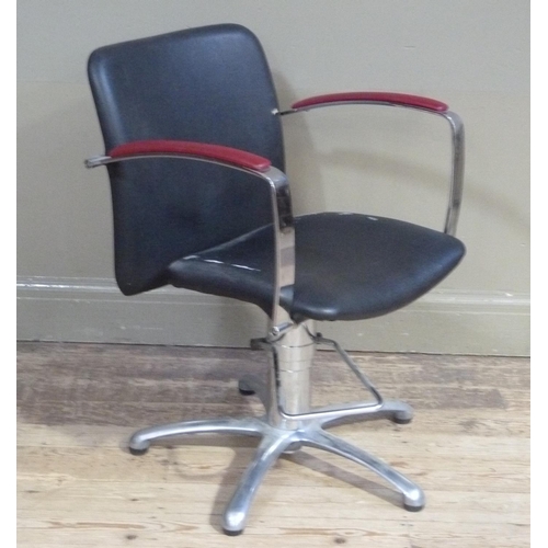 144 - A black and red vinyl upholstered office chair on metal star base
