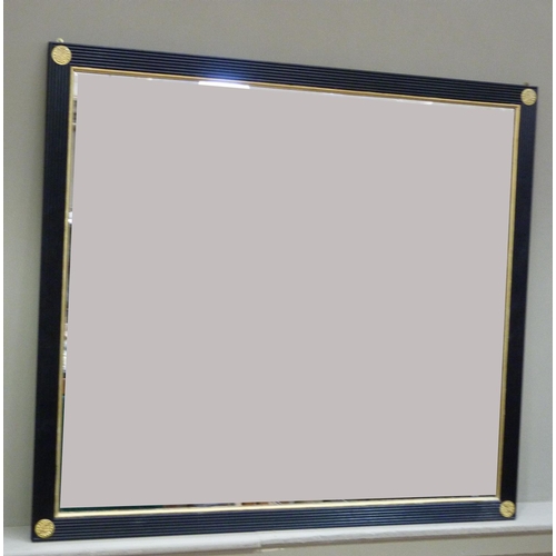 370 - A Regency style overmantle mirror with ebonised reeded frame with gilt slip and circular embossed br... 