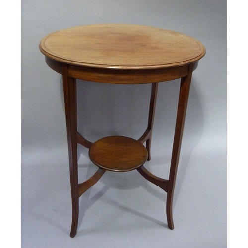 400 - An Edwardian mahogany circular two tier occasional table on splayed square tapered legs with underti... 