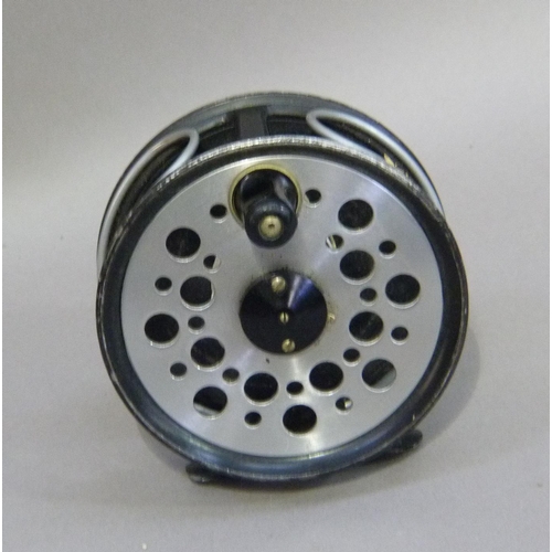 153 - A JW Young and Sons limited Beaudex fly reel with black japanned pierced aluminum spool and foot wit... 