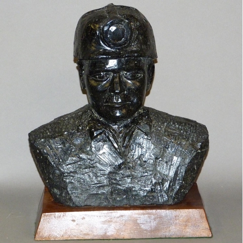 61 - JAMES STEWART (20th century), coal, head and shoulders sculpture of a miner with helmet, approximate... 