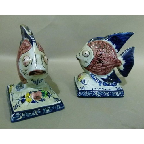 35 - A pair of Portuguese Alcobaca pottery fish ornaments decorated with black scaled pink bodies, blue t... 