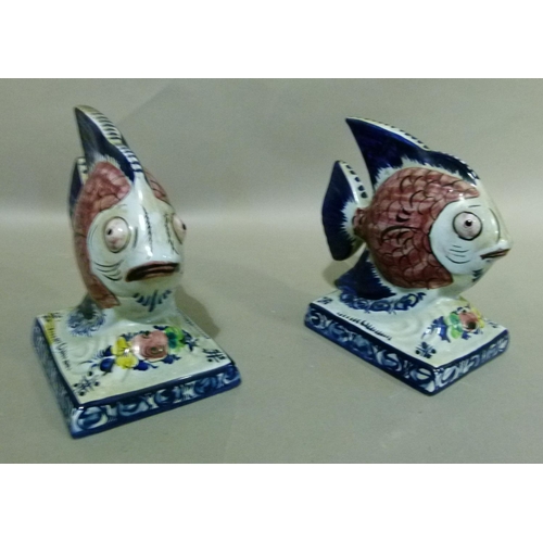 35 - A pair of Portuguese Alcobaca pottery fish ornaments decorated with black scaled pink bodies, blue t... 