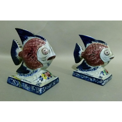 35 - A pair of Portuguese Alcobaca pottery fish ornaments decorated with black scaled pink bodies, blue t... 