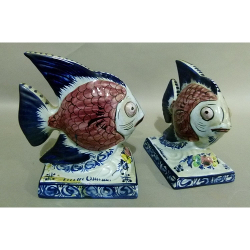 35 - A pair of Portuguese Alcobaca pottery fish ornaments decorated with black scaled pink bodies, blue t... 