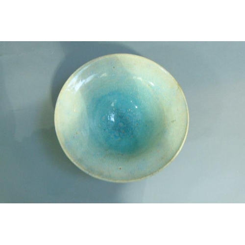 38 - A circular bowl, the raku glaze tinted from duck egg blue to turquoise, on circular foot, 32cm diame... 