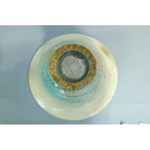 38 - A circular bowl, the raku glaze tinted from duck egg blue to turquoise, on circular foot, 32cm diame... 